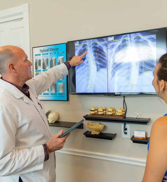 Reviewing spinal X-rays with a patient at Peterson Chiropractic